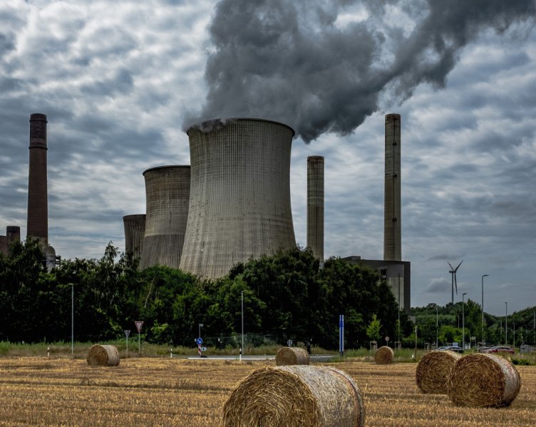 fábrica donde se ve una gran chimenea expulsando humo